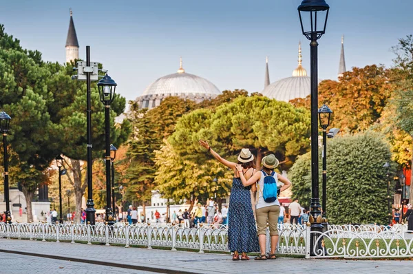 Two happy girls enjoy the breathtaking views of the sights of Istanbul. Concept of friends travel and students in Turkey