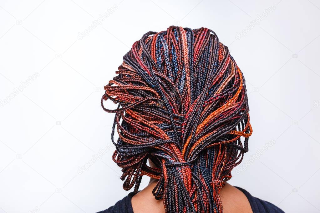 Close-up of afro pigtails braids in Zizi and Kanekalon technique with multi-colored threads and dreadlocks