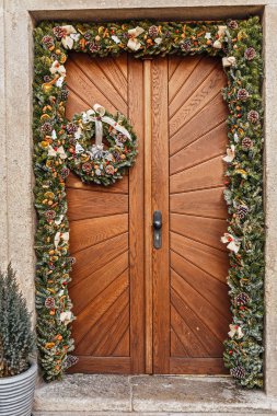 Tahta kapıya asılı Noel çelengi