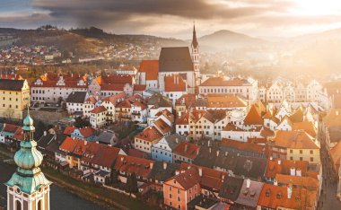 DECEMBER 2017, CESKY KRUMLOV, CZECH REPUBLIC: beautiful aerial panoramic view during sunset from the tower of the houses, castle and church in the medieval European town clipart
