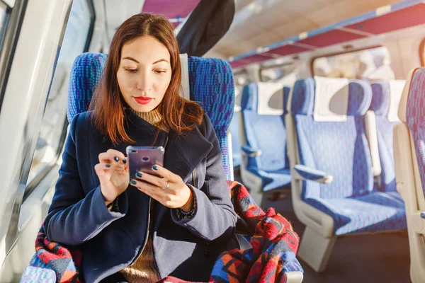 A woman is traveling on a train in a first class cabin — Stock Photo, Image