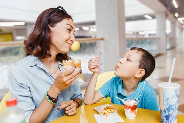 Mother And her son eating a fast food hamburher Together At The Mall — Stock Photo, Image