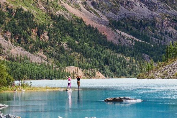 Pareja de viajeros románticos en una orilla del lago de montaña — Foto de Stock