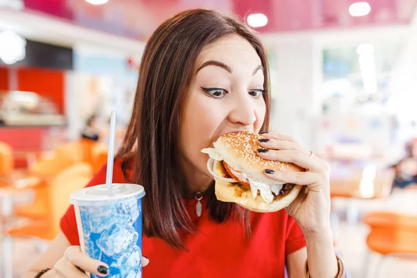 Vrouw drinken van frisdrank met hamburger in fastfood Hof in het winkelcentrum — Stockfoto