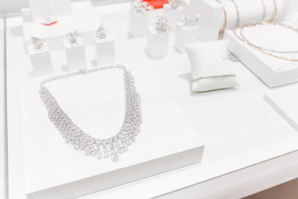 Jewelry with diamonds in the window case at jeweler's shop — Stock Photo, Image