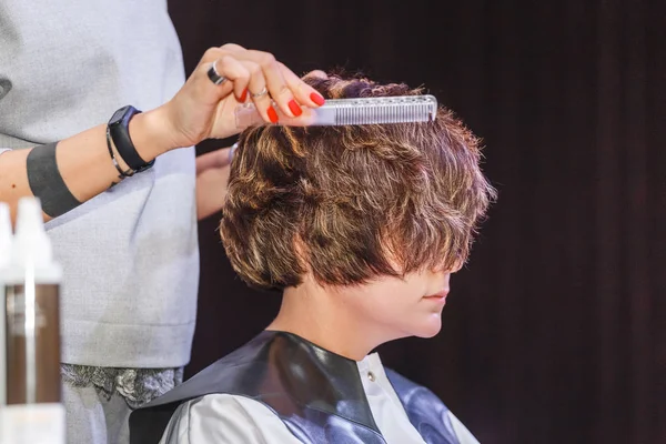 Coiffeur professionnel peigner les cheveux de la femme dans le salon, gros plan — Photo