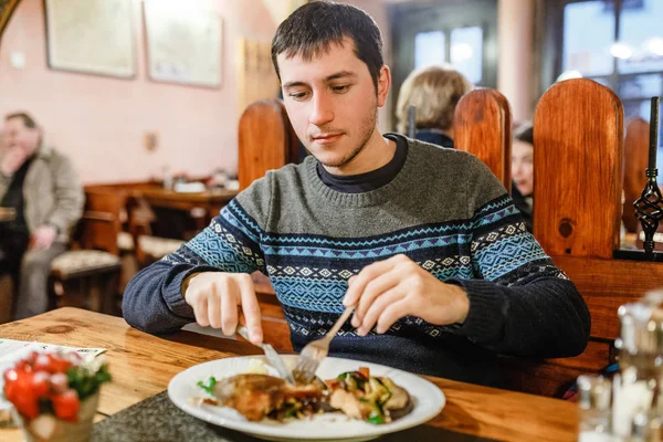 Handsome man eating christmas czech cuisine grilled or fried carp fish in restaurant — Stock Photo, Image