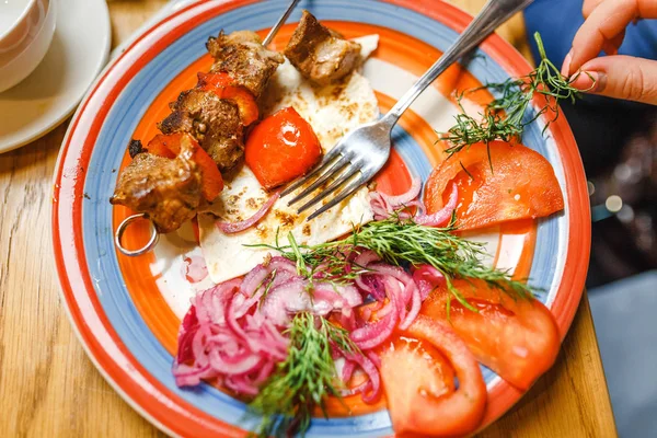 Turkish Traditional Meat Shish Kebab serving with onion, tomato and lavash on a plate in restaurant — Stock Photo, Image