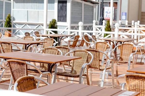 Outdoor empty street cafe tables and seats