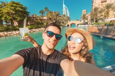 Tourism and holiday resorts - a couple in love during their honeymoon taking a selfie photo in Dubai, UAE