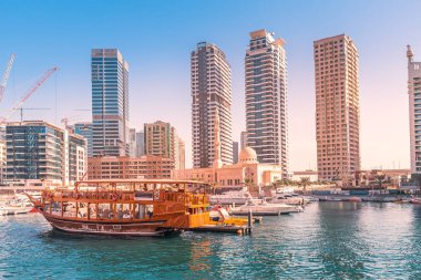 Old-fashioned wooden ferry boat cruise in Dubai Marina harbor. Tourist destinations in United Arab Emirates