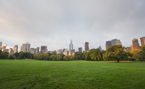 NEW YORK, USA - Sep 18, 2016: Early morning in New York City Central Park with Manhattan skyline and skyscrapers