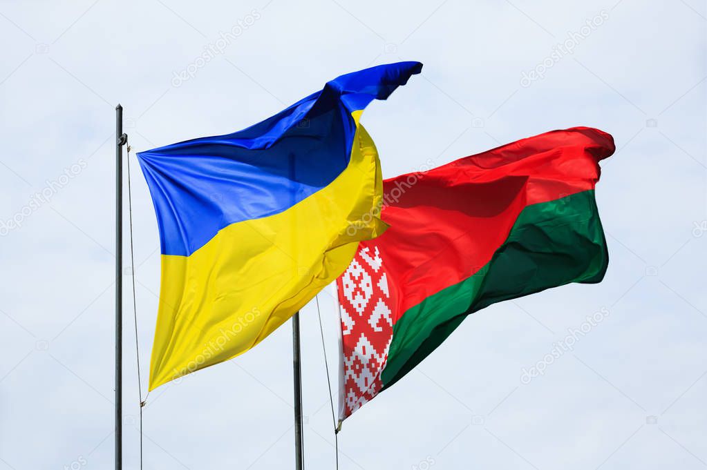 Waving flags of Ukraine and Belarus