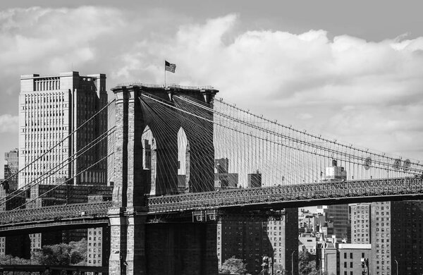 NEW YORK, USA - Apr 27, 2016: Black and white image of Brooklyn Bridge in New York City. It connects Manhattan and Brooklyn over the East River. View from Brooklyn Promenade