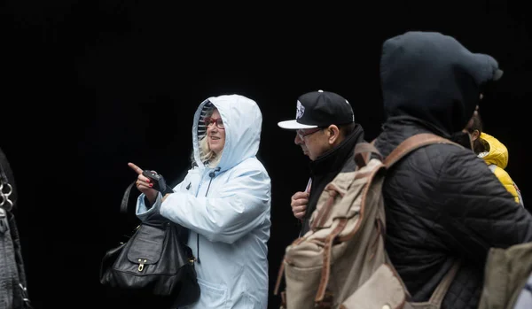 Grupp unga människor mot svart vägg — Stockfoto