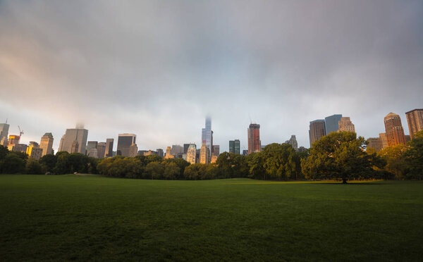 New York City Central Park with Manhattan skyline and skyscrapers early in the morning