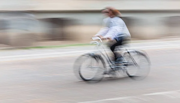 市内の道路を自転車で走る人々は — ストック写真