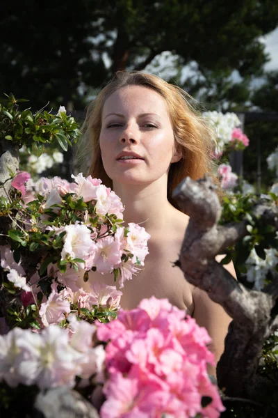Young woman among the flowers of azalea — Stock Photo, Image