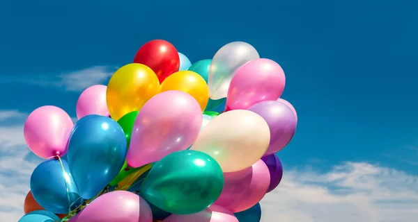 Multi-färgade ballonger på blå himmel bakgrund — Stockfoto