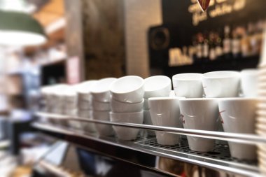 Waiting for a cup of aromatic coffee. Soft focus blurred image of a cups stand on the coffee machine. Preparation of tea or coffee clipart