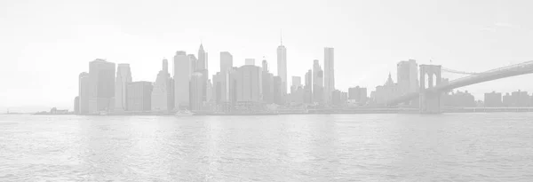 Panoramic view of Manhattan through the east river. Image in light gray tonality