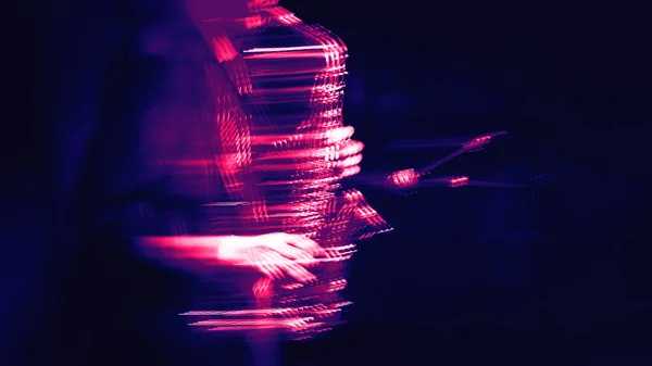 Jazz music concept.  Abstract motion blurred image of saxophone player performing on stage. Sax player going crazy. Image in trendy neon colors.