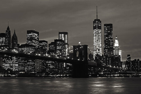 Manhattan and Brooklyn Bridge at night. Black and white image