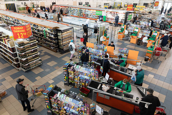 Киев, Украина - Мар. 27, 2020: Покупатели в крупном продуктовом торговом центре в Киеве покупают товары первой необходимости
