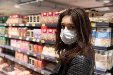 Kyiv, Ukraine - Apr. 09, 2020: Buyers in a large grocery shopping center in Kiev buy essential goods during the coronavirus pandemic clipart