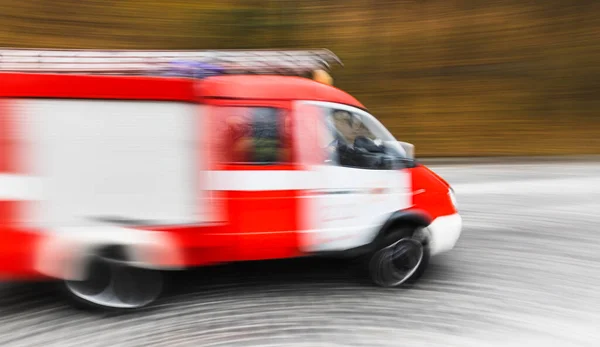 Ambulance on emergency call in motion blur. Ambulance in the city on a blurred background