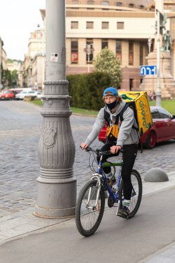Lviv, Ukrayna - 25 Mayıs 2020: Bir Glovo gıda dağıtım kuryesi Lviv, Ukrayna 'da yemek dağıtıyor.