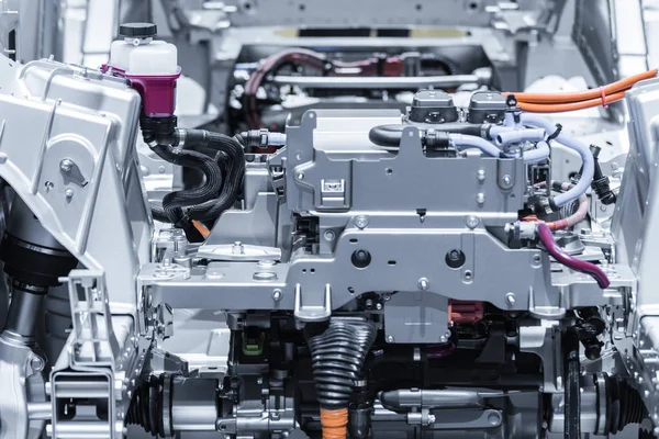 Chassis of the electric car with powertrain and power connections closeup. Blue toned. — Stock Photo, Image