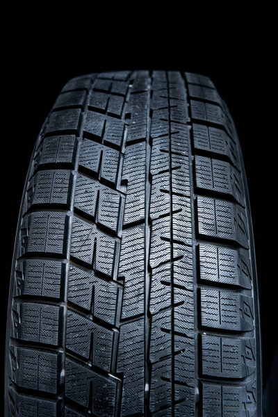 Clean Tyre. Black new shiny car tire background.