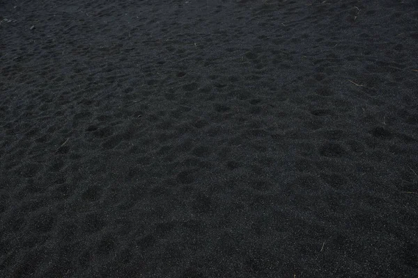 Black sand floor texture from above. Background. — Stock Photo, Image