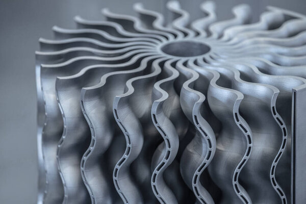 Aircraft turbine wheel printed on metal 3d printer. A model created in a laser sintering machine close-up. Concept of 4.0 industrial revolution. Progressive modern additive technology.