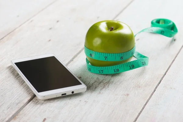 Blank smartphone with green apple — Stock Photo, Image