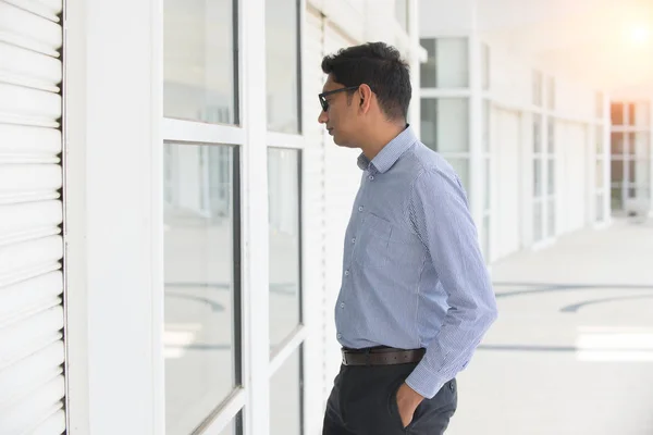 Male real estate looking in window