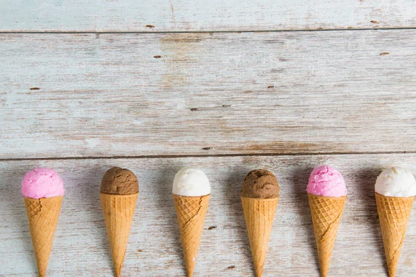 Various ice creams on wooden background — Stock Photo, Image