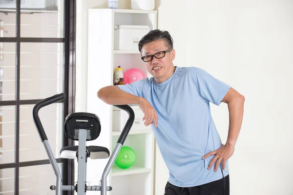 happy asian man in gym