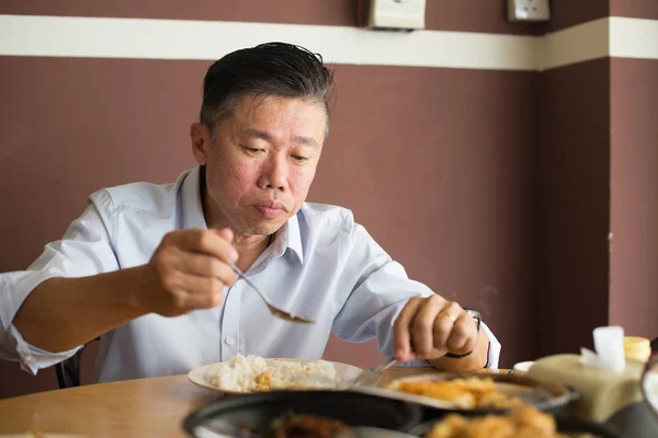 Asian matured man eating — Stock Photo, Image
