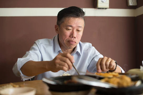 Asian matured man eating — Stock Photo, Image