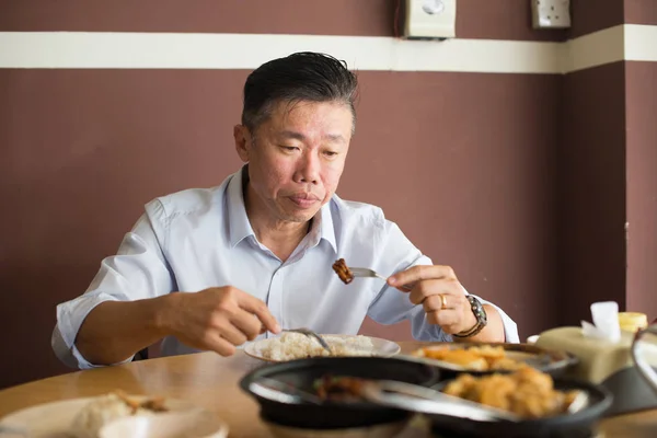 Asian matured man eating — Stock Photo, Image