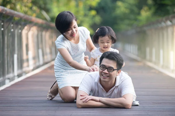 Asian family on a bridge — Stock Photo, Image