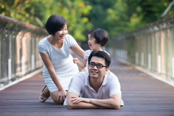 Asian family on a bridge — Stock Photo, Image