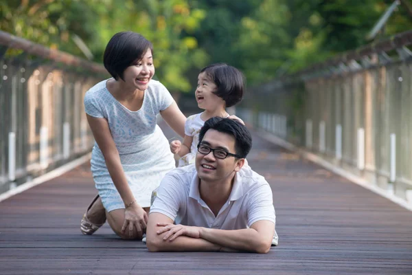 Asian family on a bridge — Stock Photo, Image