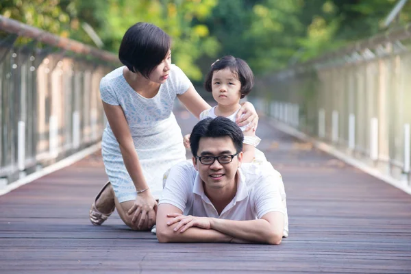 Asian family on a bridge — Stock Photo, Image