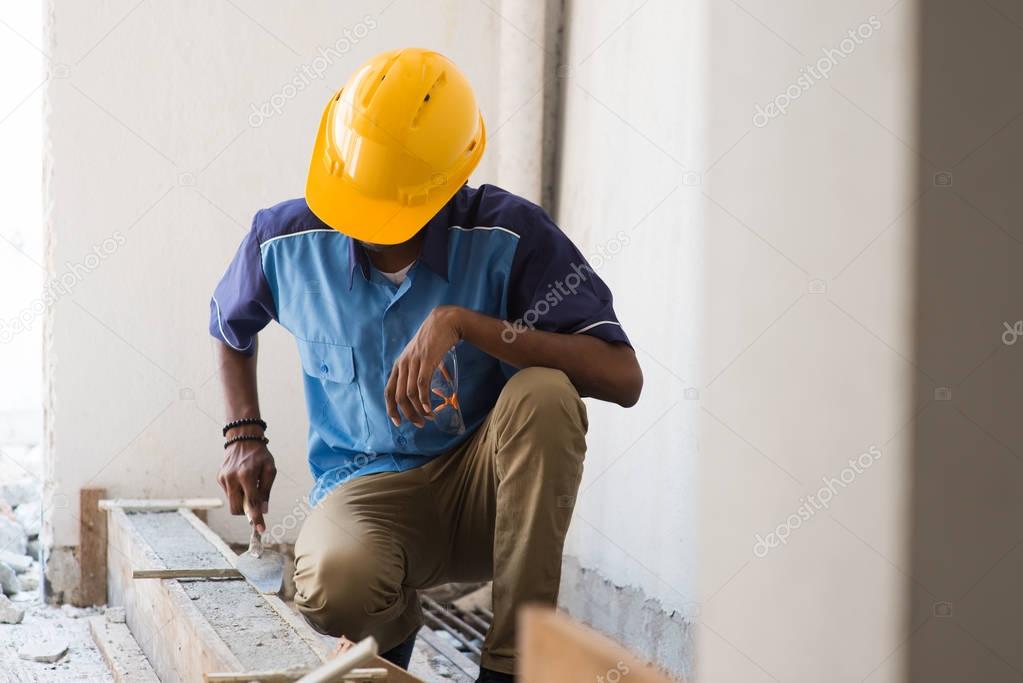 contruction worker laying bricks