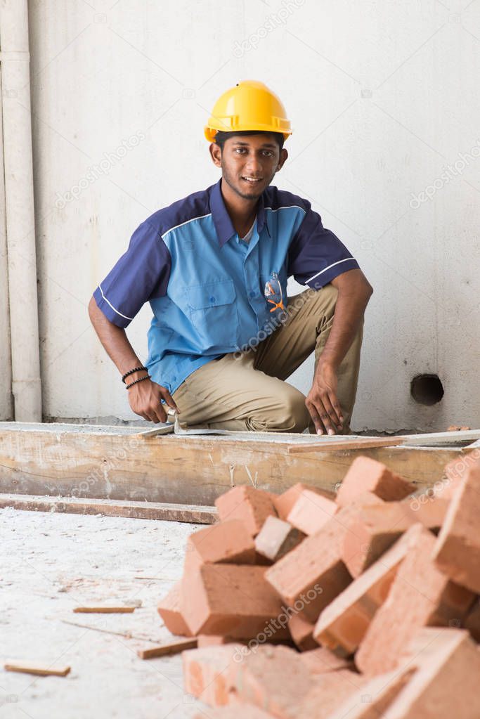 contruction worker laying bricks