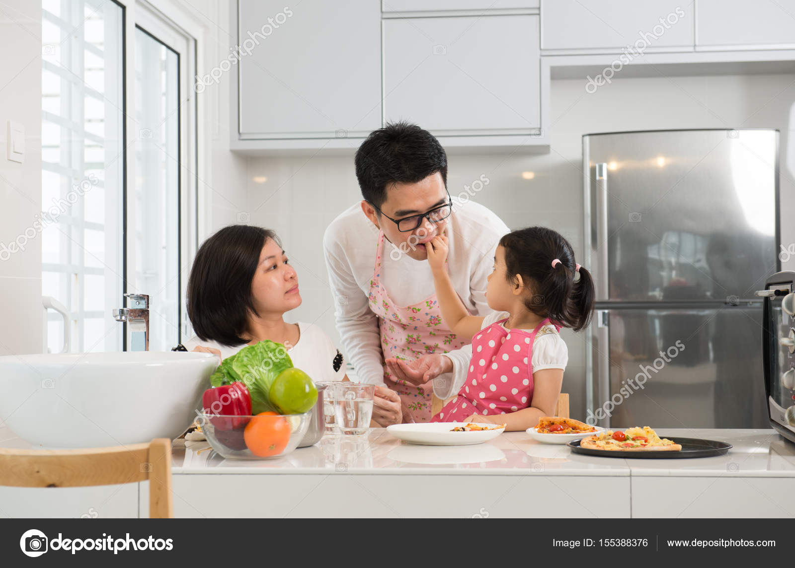 Asian family is cooking in the kitchen together