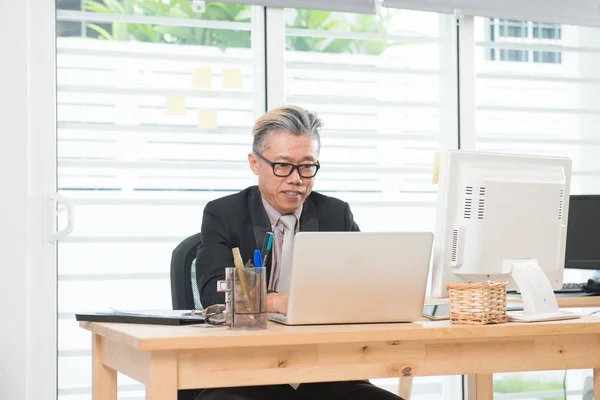 Senior asian businessman at work — Stock Photo, Image